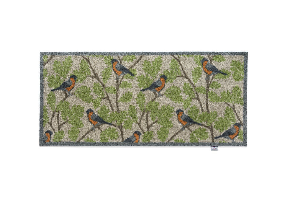 bullfinches on green branch hug rug