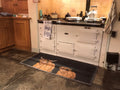 highland cow hug rug in front of white aga