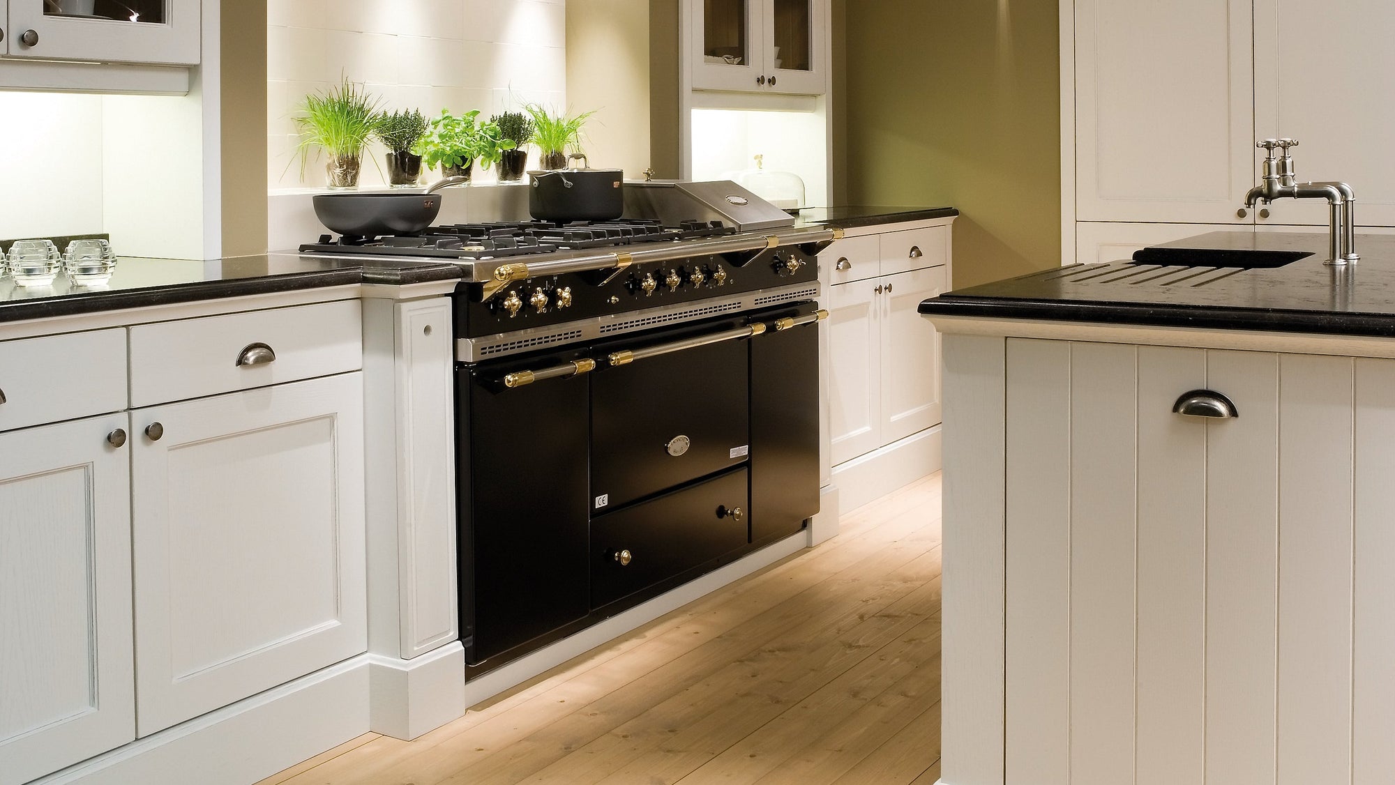 lacanche classic black cooker with brass trim in white kitchen