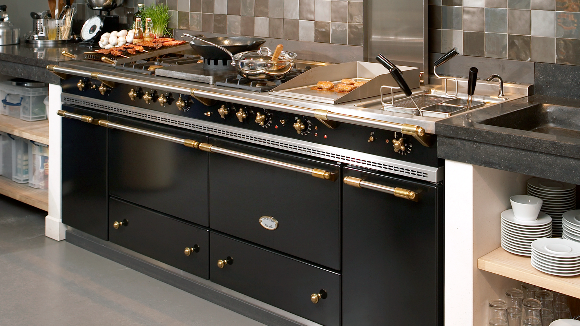 lacanche black range cooker with brass trim and integrated hob