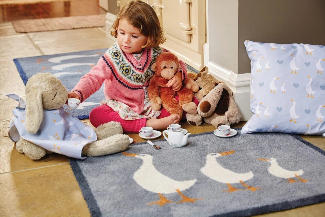 geese hug rug with child and toys